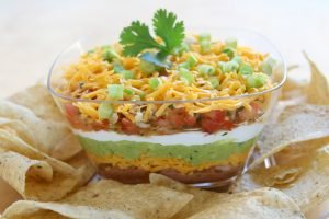 7-Layer Dip is a favorite at parties. Homemade taste enhances the flavor of the dip with a homemade twist. 